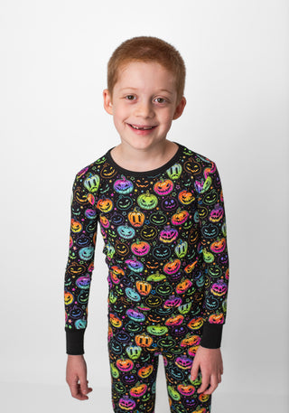 Boy wearing bamboo pajamas for toddlers and kids in Halloween Pumpkins print