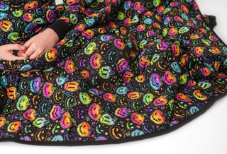 Bamboo quilted blanket for babies, toddlers, and kids in glowing neon Halloween Pumpkins print 